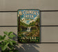 A vintage-style metal sign for McCormick's Creek State Park, featuring a scenic image of the park's waterfall and forest.