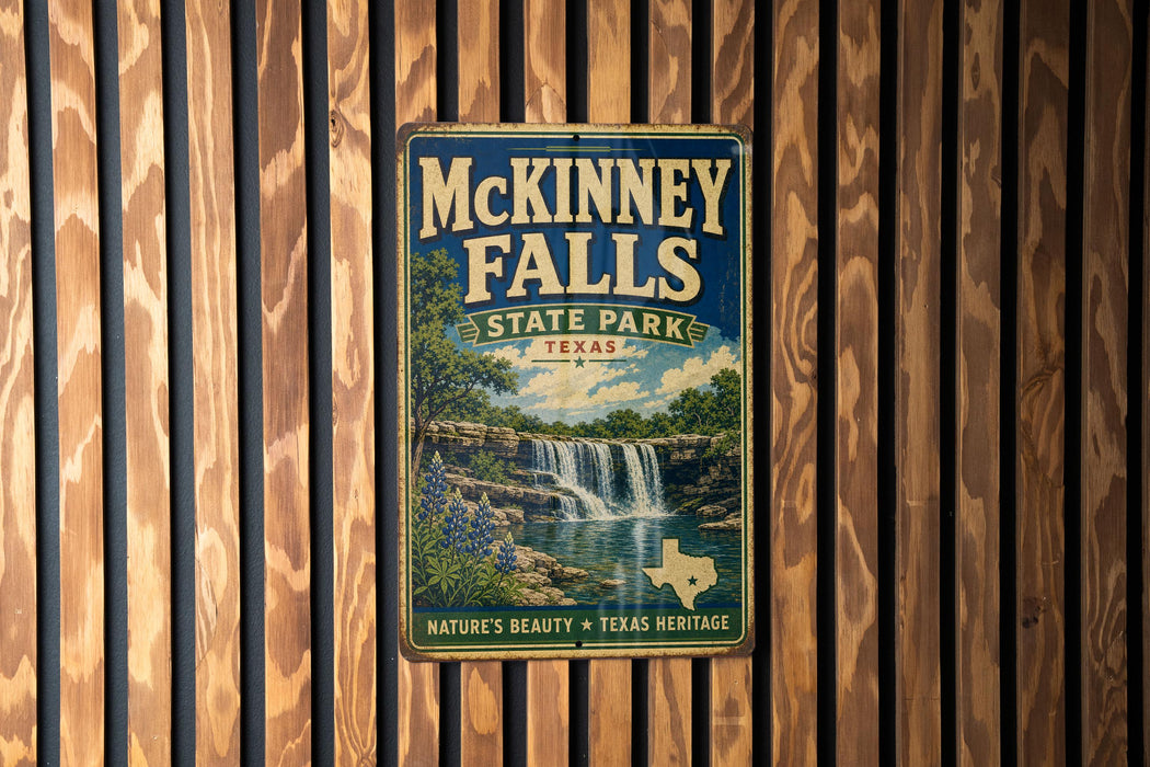 A vintage-style metal sign for McKinney Falls, a state park in Texas, is displayed on a wooden wall.