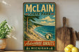 A vintage-style metal sign for Michigan State Park, featuring a scenic landscape with a beach, mountains, and a lake.