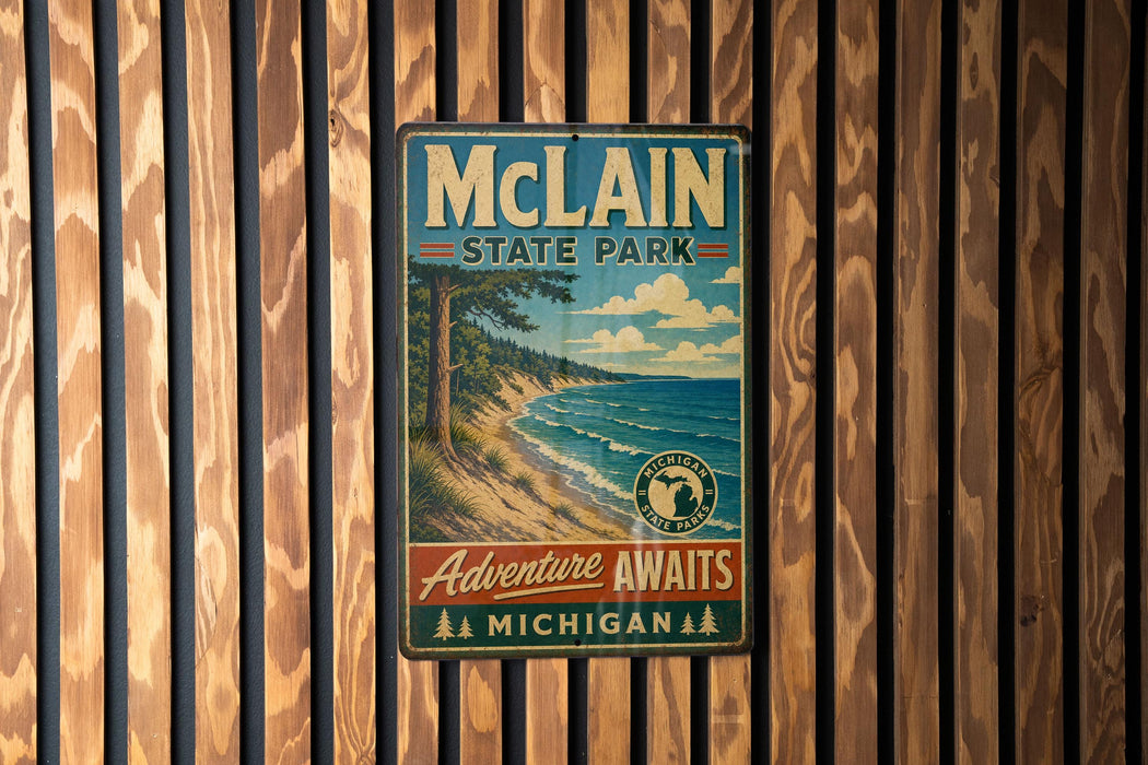 A vintage metal sign for McLain State Park, featuring a scenic landscape with a lake and mountains, hangs on a wooden wall.