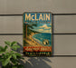 A vintage-style metal sign for Michigan State Park, featuring a scenic landscape with a beach, mountains, and a lake.