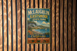 A vintage-style metal sign for McLaughlin Eastshore State Park, featuring a scenic landscape with a lake, mountains, and a sailboat.