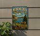 A metal sign with a scenic illustration of Medicine Creek, a state recreation area in Nebraska, featuring a deer in the foreground and a lake in the background.