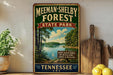 A vintage-style sign for Meeman-Shelby Forest State Park in Tennessee, featuring a scenic landscape with a lake and trees.