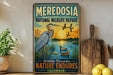 A vintage-style sign for the Meredosa National Wildlife Refuge in Illinois, featuring an illustration of a heron and ducks in a natural setting.