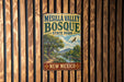 A vintage metal sign for Mesilla Valley Bosque State Park in New Mexico, featuring a scenic landscape with a river and mountains.