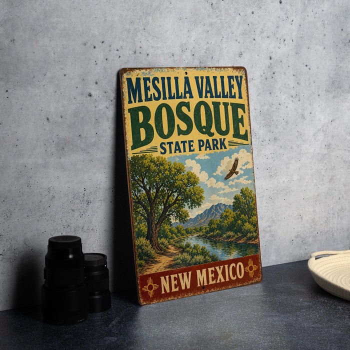 A vintage-style metal sign for Mesilla Valley Bosque State Park in New Mexico, featuring a scenic landscape with a river and mountains.