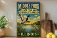 A vintage-style sign for the Middle Fork State Fish and Wildlife Area in Illinois, featuring an illustration of ducks and a scenic landscape.