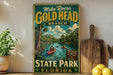 A vintage-style sign for Mike Roess Gold Head Branch, featuring a scenic illustration of a river with kayakers and palm trees.