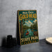 A vintage-style metal sign for Mike Roess Gold Head Branch State Park in Florida, featuring a scenic image of a river with a person kayaking.