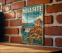 A vintage-style sign for Millsite State Park in Utah, featuring a scenic illustration of a waterfall and mountains.