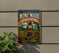 A vintage-style metal sign for the Kentucky Mine-Made Adventure Park, featuring colorful illustrations and text.