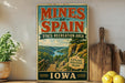 a vintage-style sign for the state recreation area of Iowa, with a scenic illustration of a river and mountains.