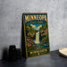 A vintage-style sign for Minnesota State Park, featuring a waterfall and lush greenery, is displayed on a gray concrete surface.