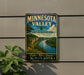 A vintage Minnesota Valley sign is displayed on a wall, featuring a scenic landscape of a river and mountains.