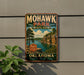 A vintage-style metal sign for Mohawk Park, Oklahoma, featuring a scenic landscape with a lake and mountains.