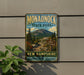 A vintage-style metal sign for Monadnock State Park, featuring a scenic mountain landscape and trail signs, is displayed on a wall next to a plant.
