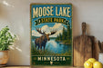 A vintage-style metal sign for Moose Lake State Park in Minnesota, featuring a moose standing in a grassy area with a lake in the background.