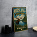 A vintage-style metal sign for Moose Lake State Park in Minnesota, featuring an illustration of a moose standing in front of a lake surrounded by pine trees.