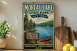 a vintage-style sign for Moreau Lake State Park, New York, with a scenic illustration of the lake, forests, fields, and a sailboat.