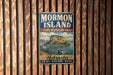 A vintage-style metal sign for Mormon Island, the State Recreation Area in Nebraska, featuring a scenic illustration of a mountain and a lake.