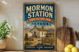 A vintage-style sign for Mormon Station State Historic Park in Nevada, featuring an illustration of a wagon and a sign that reads "A REMINDER OF NEVADA PIONEER HERITAGE".