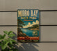 A vintage-style metal sign for Moro Bay State Park in Arkansas, featuring a scenic landscape with a lake, mountains, and pine trees.
