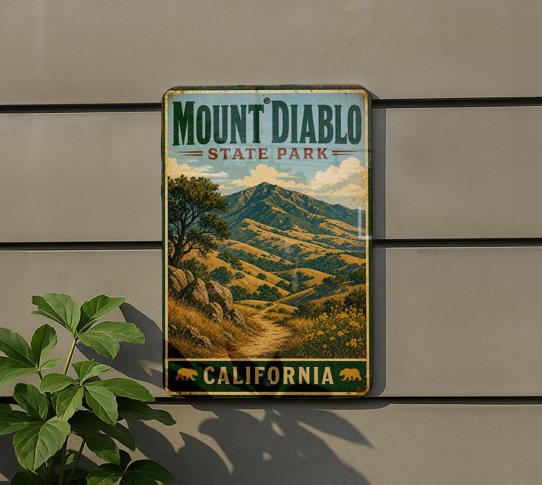 A vintage-style metal sign for Mount Diablo State Park in California, featuring a scenic mountain landscape with a winding path and trees.