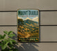 A vintage-style metal sign for Mount Diablo State Park in California, featuring a scenic mountain landscape with a winding path and trees.
