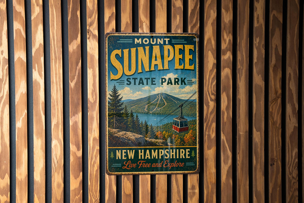 A vintage metal sign for Mount Sunapee State Park in New Hampshire, featuring a scenic mountain landscape with a cable car and the text "Live Free and Explore".