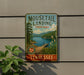 A vintage-style metal sign for Mouselail Landing State Park in Tennessee, featuring a scenic landscape with a lake, mountains, and a wooden dock.