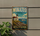 A vintage-style metal sign for Mukilteo State Park in Washington, featuring a lighthouse and a boat on the water.