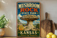 A vintage-style metal sign advertising Mushroom Rock State Park in Kansas, featuring a large mushroom formation in the background.