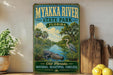 A vintage-style sign for the Myakka River State Park in Florida, featuring an illustration of a bird, a crocodile, and a palm tree.