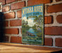 A vintage-style metal sign for Myakka River State Park in Florida, featuring a scenic illustration of the river, palm trees, and a bird.