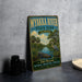 A vintage-style metal sign for Myakka River State Park, Florida, featuring an illustration of a river, palm trees, and a bird.