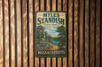 A vintage metal sign for Myles Standish State Forest in Massachusetts, featuring a scenic illustration of a forest and a lake.