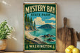 A vintage-style metal sign for Mystery Bay State Park in Washington, featuring a scenic landscape with a beach, mountains, and a body of water.
