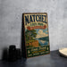A vintage-style sign for Natchez State Park, Mississippi, featuring a scenic landscape with a river, trees, and mountains.