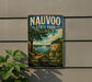 A vintage-style metal sign for Nauvoo State Park in Illinois, featuring a scenic landscape with a lake and mountains.