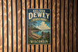 A vintage-style metal sign for Nelson Dewey State Park in Wisconsin, featuring a scenic landscape with a lake, trees, and mountains.