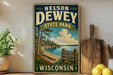 A vintage-style sign for Nelson Dewey State Park in Wisconsin, featuring a scenic landscape with pine trees, a lake, and mountains.