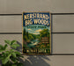 A vintage-style sign fornersand-big woods state park in Minnesota, featuring a scenic illustration of a forest, a waterfall, and a trail.
