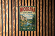 A vintage metal sign for Niobrara State Park in Nebraska, featuring a scenic landscape with a river and mountains.