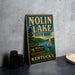 A vintage-style sign for Nolin Lake State Park in Kentucky, featuring a scenic image of a lake with a sailboat and mountains in the background.