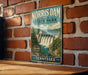 A vintage-style metal sign for the Norris Dam State Park in Tennessee, featuring a scenic illustration of the dam and surrounding landscape.