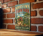 A vintage metal sign for Norristown Farm Park, featuring illustrations of farm animals and a barn, is displayed on a brick wall.