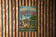 A vintage metal sign for Norristown Farm Park, featuring a barn, windmill, and farm animals, is displayed on a wooden wall.