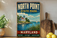 A vintage-style metal sign for North Point State Park in Maryland, featuring a lighthouse and a serene body of water.