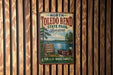A vintage metal sign for North Toledo Bend State Park in Louisiana, featuring a scenic illustration of a lake, trees, and a boat.